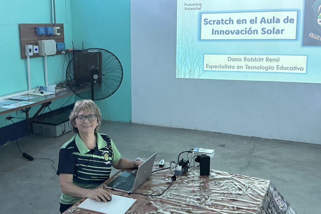 Regional Director Dana Rensi at a conference table with her presentation on Scratch software