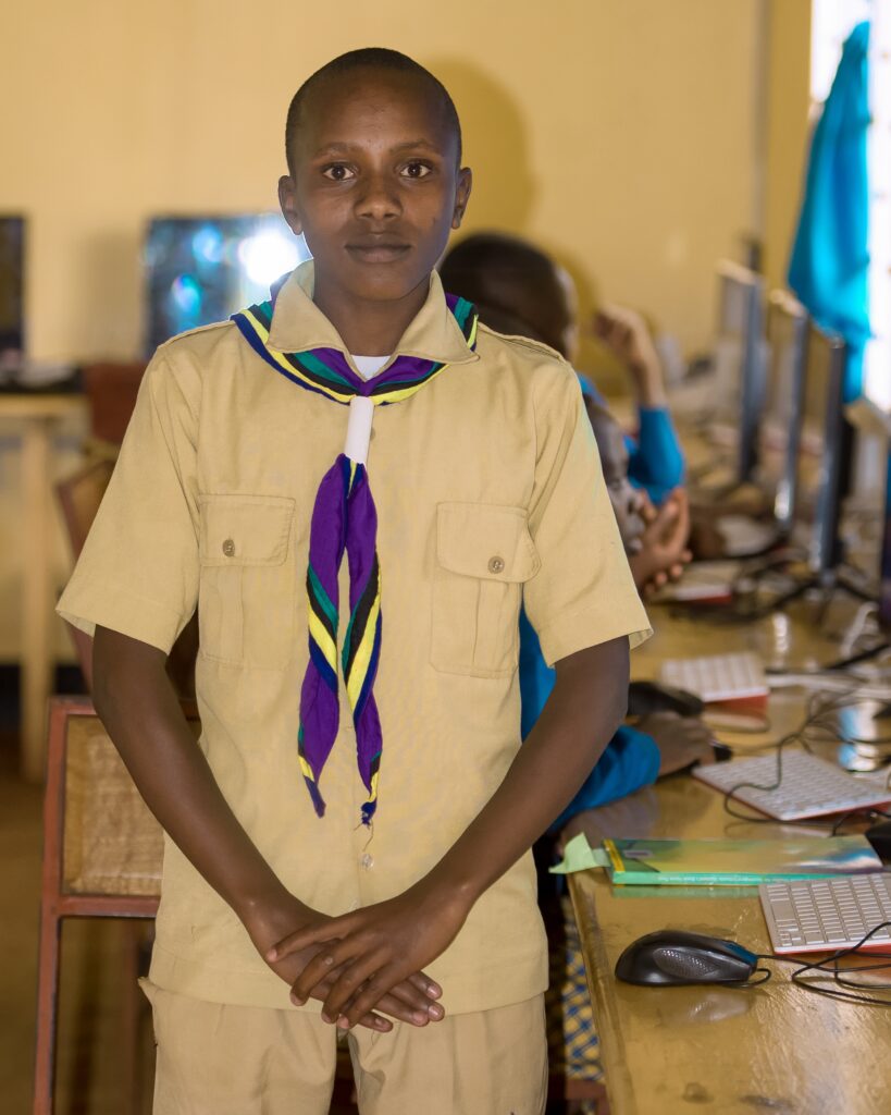 Student Samwel stands in a computer lab in a school in Tanzania